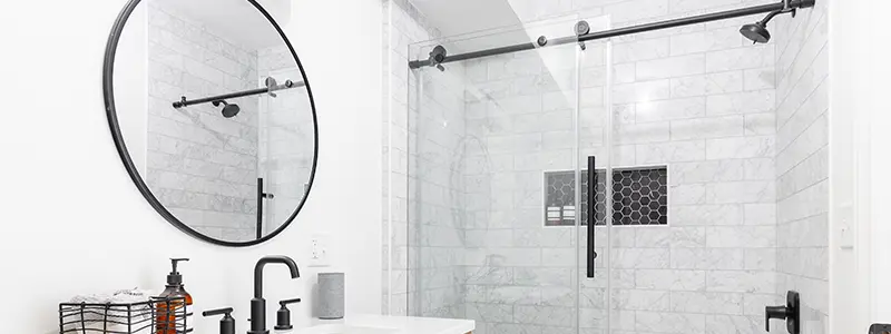 bathroom with custom mirror and shower doors